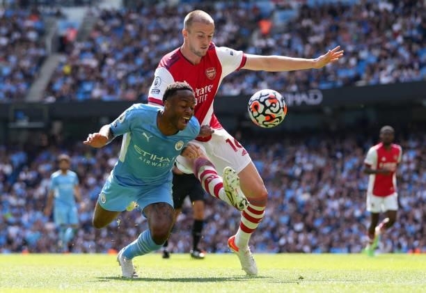 Raheem Sterling of Manchester City battles for possession with Rob Holding of Arsenal during the Premier League match between Manchester City and...