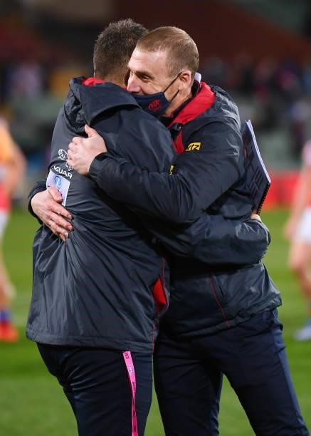 Simon Goodwin coach of the Demons hugs his coaching staff after winning the AFL First Qualifying Final match between Melbourne Demons and Brisbane...