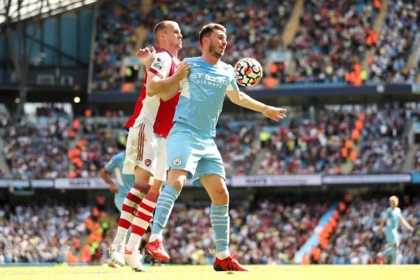 Aymeric Laporte of Manchester City is challenged by Rob Holding of Arsenal during the Premier League match between Manchester City and Arsenal at...