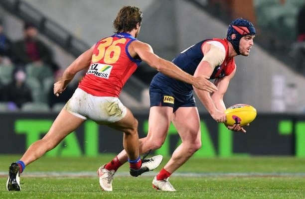 Angus Brayshaw of the Demons handballs in front of Rhys Mathieson of the Lions during the AFL First Qualifying Final match between Melbourne Demons...