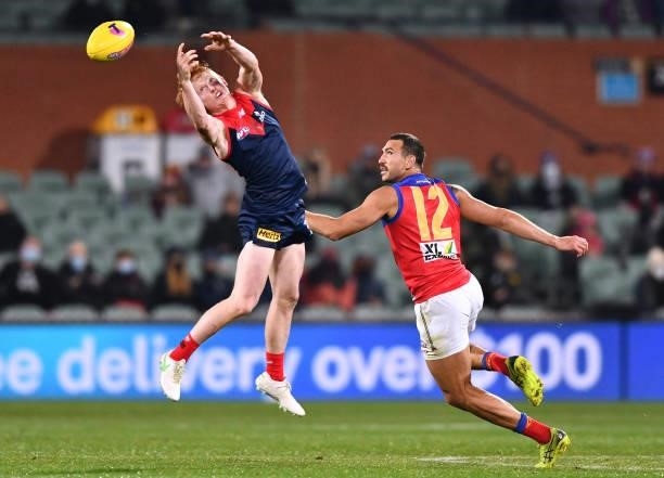 Jake Bowey of the Demons competes for the ball against Nakia Cockatoo of the Lions during the AFL First Qualifying Final match between Melbourne...
