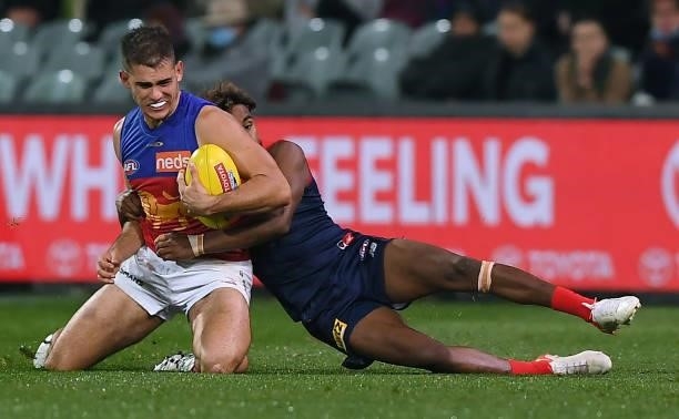 Brandon Starcevich of the Lions tackled by Kysaiah Pickett of the Demons during the AFL First Qualifying Final match between Melbourne Demons and...