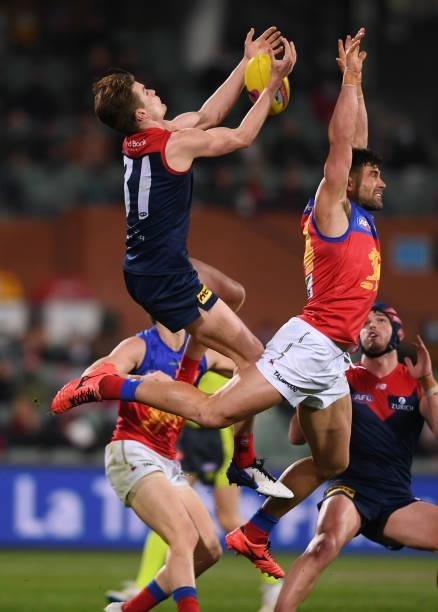 Bayley Frisch of the Demons competes for the ball against Archie Smith of the Lions during the AFL First Qualifying Final match between Melbourne...