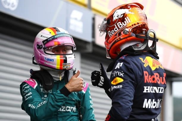 Pole position qualifier Max Verstappen of Netherlands and Red Bull Racing celebrates with Sebastian Vettel of Germany and Aston Martin F1 Team in...