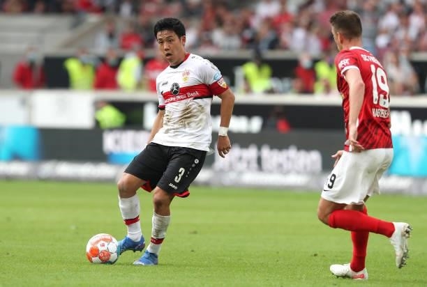 Wataru Endo of VfB Stuttgart is challenged by Janik Haberer of Sport-Club Freiburg during the Bundesliga match between VfB Stuttgart and Sport-Club...
