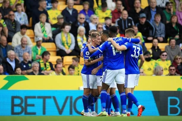 Marc Albrighton of Leicester City celebrates with teammates after scoring his team's second goal during the Premier League match between Norwich City...