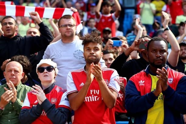 Arsenal fans applaud their team after the Premier League match between Manchester City and Arsenal at Etihad Stadium on August 28, 2021 in...