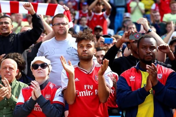 Arsenal fans applaud their team after the Premier League match between Manchester City and Arsenal at Etihad Stadium on August 28, 2021 in...