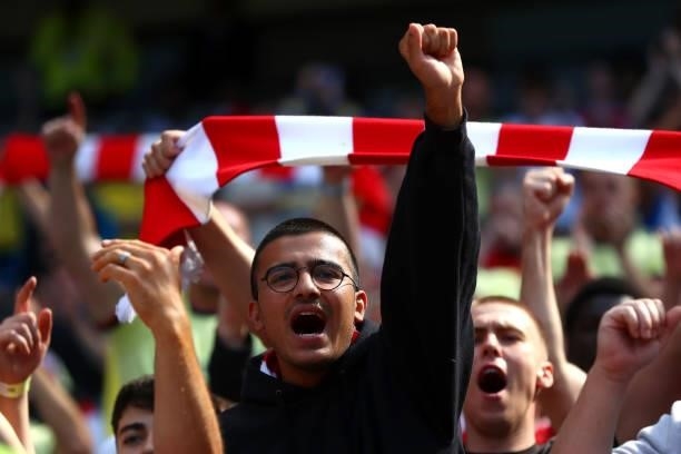Arsenal fans cheer on their team during the Premier League match between Manchester City and Arsenal at Etihad Stadium on August 28, 2021 in...