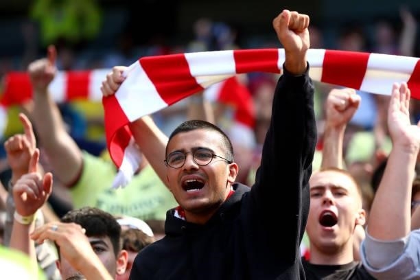 Arsenal fans cheer on their team during the Premier League match between Manchester City and Arsenal at Etihad Stadium on August 28, 2021 in...