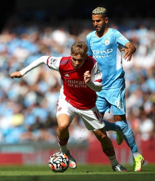 Emile Smith Rowe of Arsenal controls the ball under pressure of Riyad Mahrez of Manchester City during the Premier League match between Manchester...