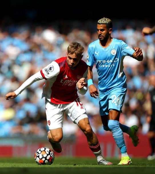 Emile Smith Rowe of Arsenal controls the ball under pressure of Riyad Mahrez of Manchester City during the Premier League match between Manchester...