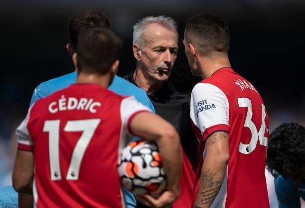 Referee Martin Atkinson talks to Granit Xhaka of Arsenal after he sends him off during the Premier League match between Manchester City and Arsenal...