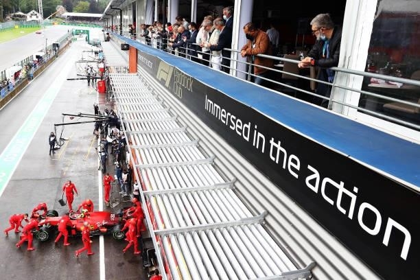 Fans look on as Carlos Sainz of Spain driving the Scuderia Ferrari SF21 stops in the Pitlane during qualifying ahead of the F1 Grand Prix of Belgium...