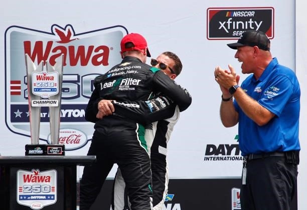 Allmendinger, driver of the Hyperice Chevrolet, congratulates Justin Haley, driver of the LeafFilter Gutter Protection Chevrolet, as Chris Rice is...