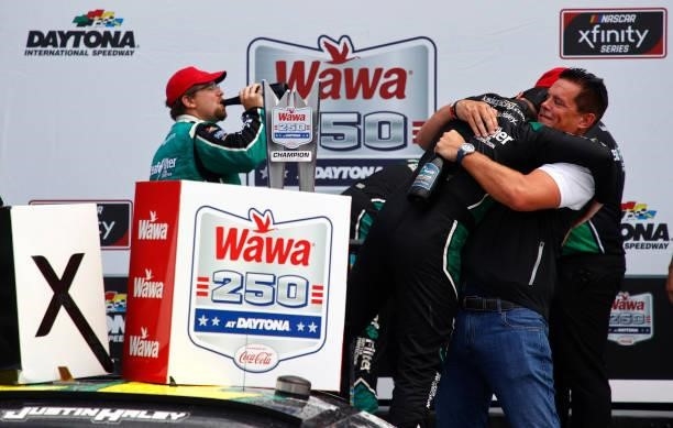 Matt Kaulig, owner of Kaulig Racing hugs Justin Haley, driver of the LeafFilter Gutter Protection Chevrolet, in the Ruoff Mortgage victory lane after...
