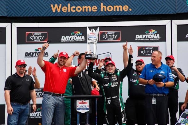 Justin Haley, driver of the LeafFilter Gutter Protection Chevrolet, and crew celebrate in the Ruoff Mortgage victory lane after winning the NASCAR...