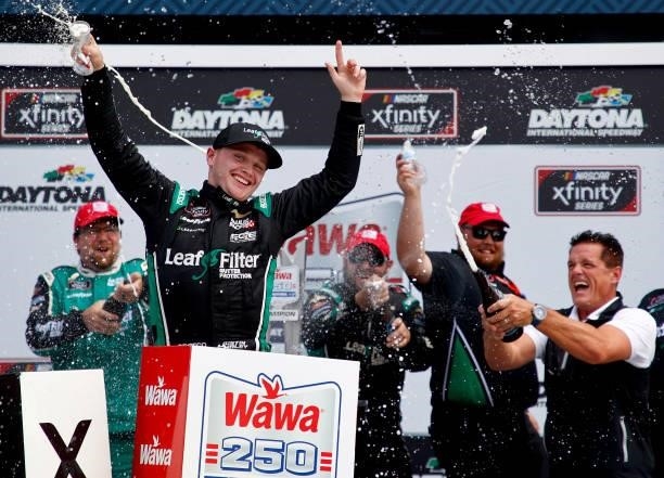 Justin Haley, driver of the LeafFilter Gutter Protection Chevrolet, celebrates in the Ruoff Mortgage victory lane after winning the NASCAR Xfinity...