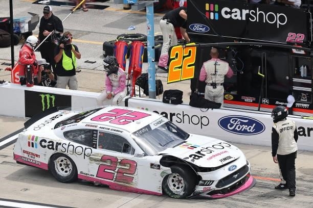 Austin Cindric, driver of the Car Shop Ford, exits his car in the pit area after an on-track incident during the NASCAR Xfinity Series Wawa 250 at...