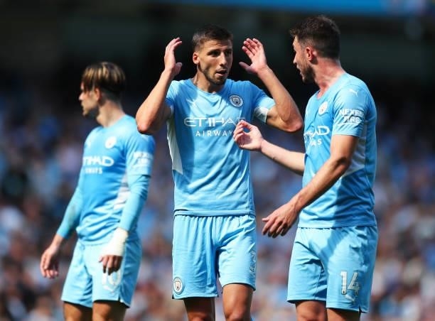 Aymeric Laporte of Manchester City talks tactics with teammate Ruben Dias in action during the Premier League match between Manchester City and...