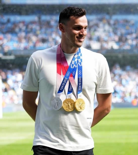Olympic Athlete James Guy wears his medals at half time during the Premier League match between Manchester City and Arsenal at Etihad Stadium on...