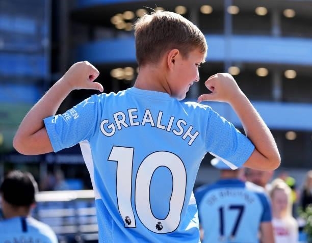 Young fan wears a Jack Grealish Manchester City home shirt during the Premier League match between Manchester City and Arsenal at Etihad Stadium on...