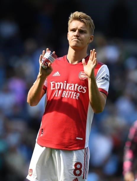 Martin Odegaard applauds the Arsenal fans after the Premier League match between Manchester City and Arsenal at Etihad Stadium on August 28, 2021 in...