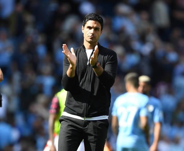 Manager Mikel Arteta applauds the Arsenal fans after the Premier League match between Manchester City and Arsenal at Etihad Stadium on August 28,...