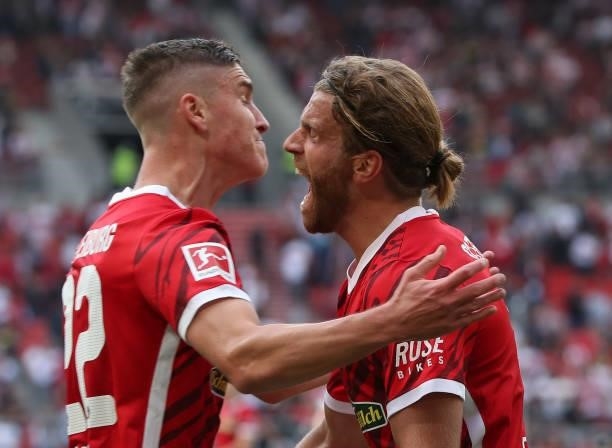Lucas Hoeler of Sport-Club Freiburg celebrates after scoring his team's third goal with teammate Roland Sallai during the Bundesliga match between...