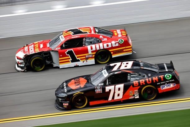 Michael Annett, driver of the PFJ Thank A Trucker Chevrolet, and Mason Massey, driver of the BRUNT Workwear Toyota, race during the NASCAR Xfinity...