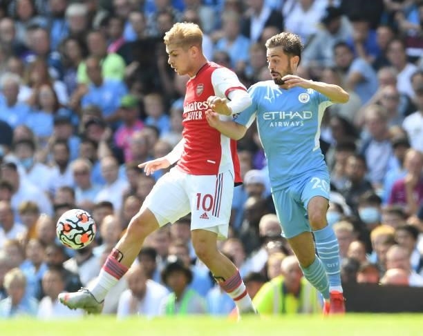 Emile Smith Rowe of Arsenal takes on Bernando Silva of Man City during the Premier League match between Manchester City and Arsenal at Etihad Stadium...