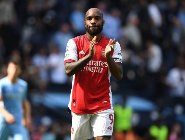 Alex Lacazette applauds the Arsenal fans after the Premier League match between Manchester City and Arsenal at Etihad Stadium on August 28, 2021 in...