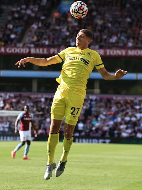 Vitaly Janelt of Brentford heads the ball during the Premier League match between Aston Villa and Brentford at Villa Park on August 28, 2021 in...