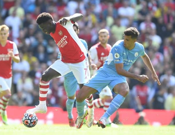 Bukayo Saka of Arsenal takes on Joao Cancelo of Man City during the Premier League match between Manchester City and Arsenal at Etihad Stadium on...