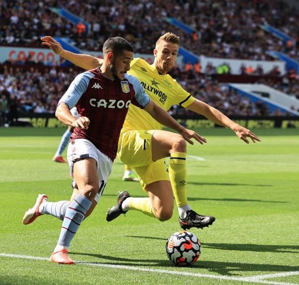 Emiliano Buendia of Aston Villa is tackled by Kristoffer Ajer during the Premier League match between Aston Villa and Brentford at Villa Park on...
