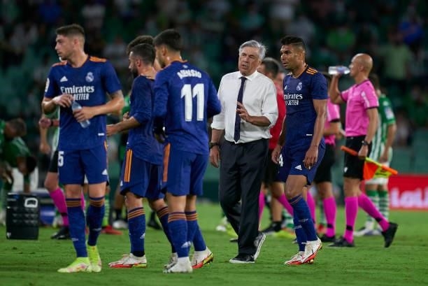 Carlo Ancelotti, Manager of Real Madrid speaks with his players during a break in play during the La Liga Santander match between Real Betis and Real...