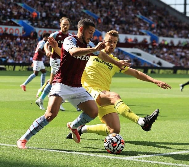 Emiliano Buendia of Aston Villa is tackled by Kristoffer Ajer during the Premier League match between Aston Villa and Brentford at Villa Park on...