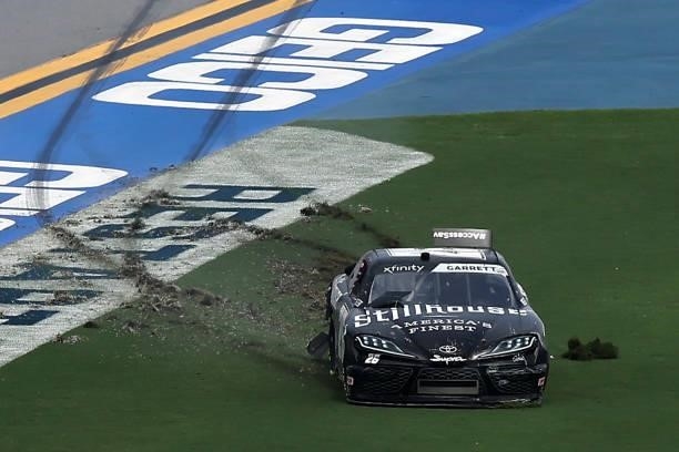 Colin Garrett, driver of the Stillhouse Toyota, spins into the infield grass after an on-track incident during the NASCAR Xfinity Series Wawa 250 at...