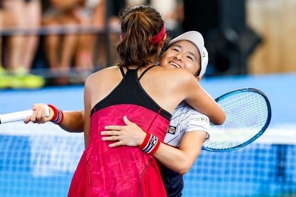 Shuko Aoyama of Japan and Ena Shibahara of Japan hug after winning their final doubles match against Sania Mirza of India and Christina McHale of USA...