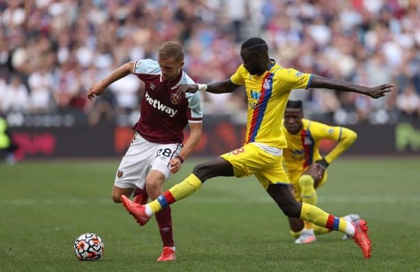 Tomas Soucek of West Ham United is challenged by Cheikhou Kouyate of Crystal Palace during the Premier League match between West Ham United and...