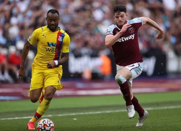 Jordan Ayew of Crystal Palace is chased by Declan Rice of West Ham United during the Premier League match between West Ham United and Crystal Palace...