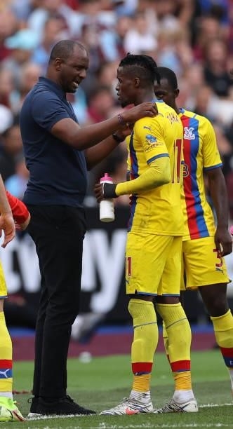 Manager of Crystal Palace Patrick Viera talks to Wilfried Zaha of Crystal Palace during the Premier League match between West Ham United and Crystal...