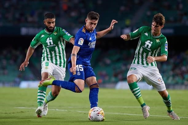 Nabil Fekir and Juan Miranda of Real Betis compete for the ball with Federico Valverde of Real Madrid during the La Liga Santader match between Real...
