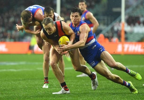Mason Redman of the Bombers is tackled by Laitham Vandermeer of the Bulldogs during the AFL First Elimination Final match between Western Bulldogs...
