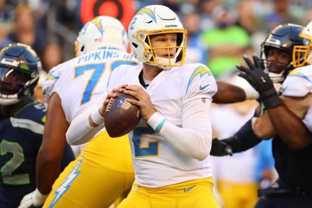 Easton Stick of the Los Angeles Chargers looks to throw the ball against the Seattle Seahawks in the first quarter during the NFL preseason game at...
