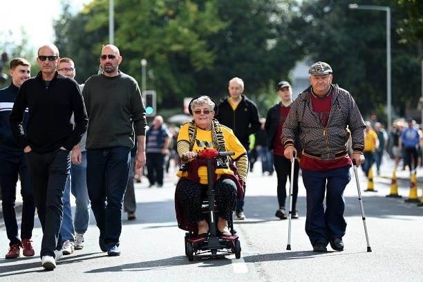 Fans make their way towards the stadium ahead of the Premier League match between Wolverhampton Wanderers and Manchester United at Molineux on August...