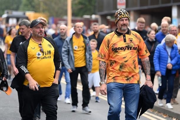 Fans make their way towards the stadium ahead of the Premier League match between Wolverhampton Wanderers and Manchester United at Molineux on August...