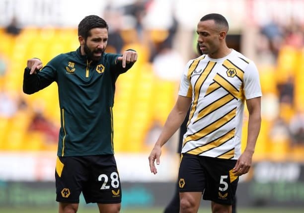 Joao Moutinho and Marcal of Wolverhampton Wanderers interact ahead of the Premier League match between Wolverhampton Wanderers and Manchester United...