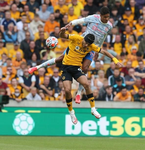 Raphael Varane of Manchester United in action with Raul Jimenez of Wolverhampton Wanderers during the Premier League match between Wolverhampton...