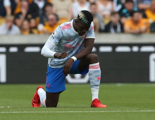 Paul Pogba of Manchester United takes a knee in support of the Black Lives Matter campaign ahead of the Premier League match between Wolverhampton...